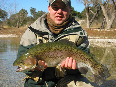 Rob Burlingame wraps his hands around the fly-fishing state record rainbow trout. Photo by Todd Fleming.